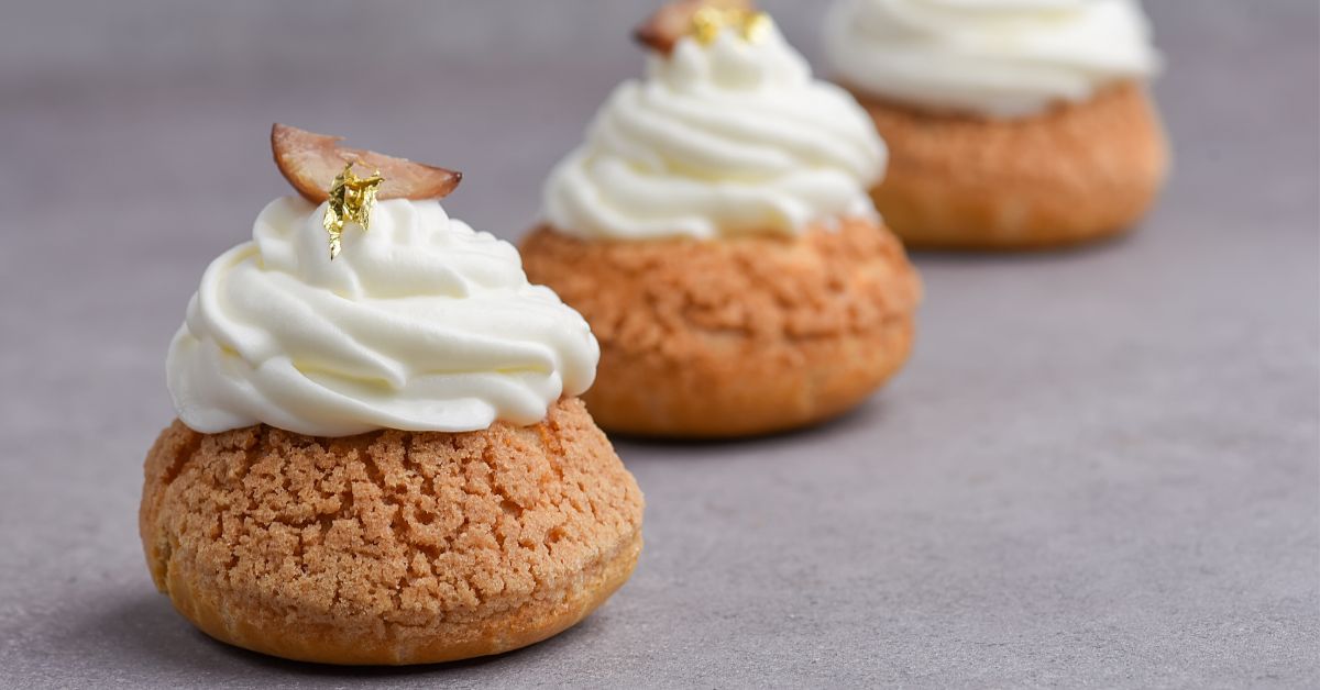 Cream puffs topped with whipped cream.