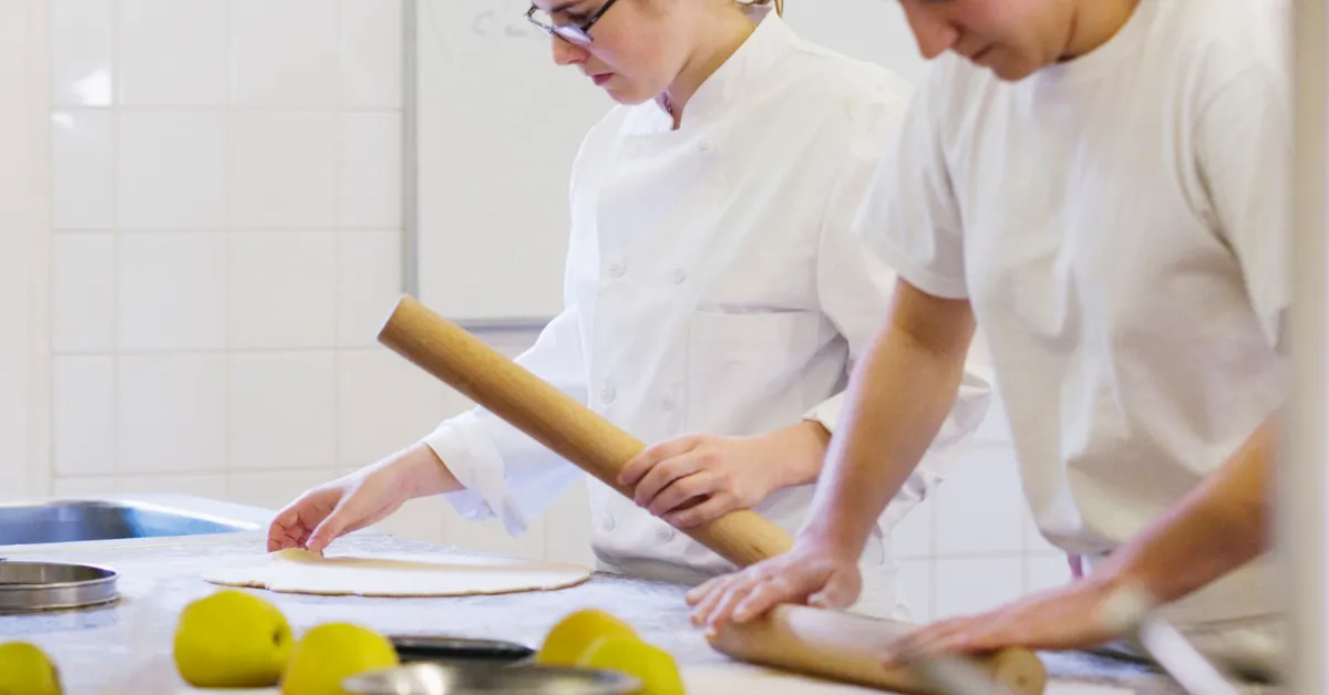 teens baking and rolling out dough