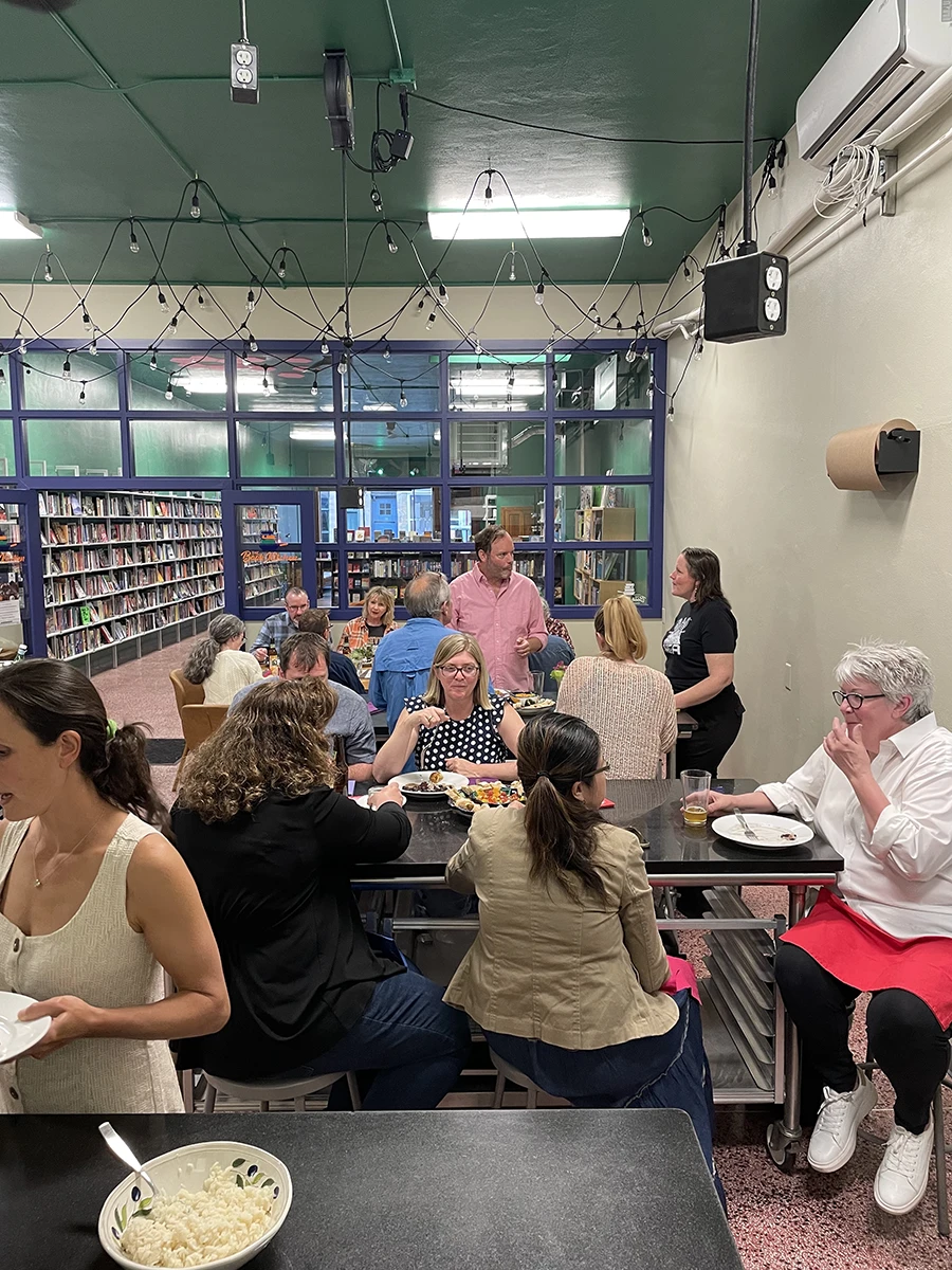 People sitting and enjoying food inside the book kitchen