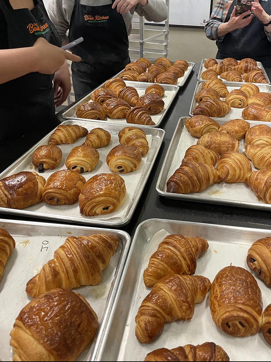 Freshly baked croissants on sheet trays