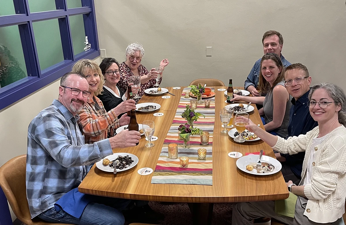 A group of people enjoying a meal around a table