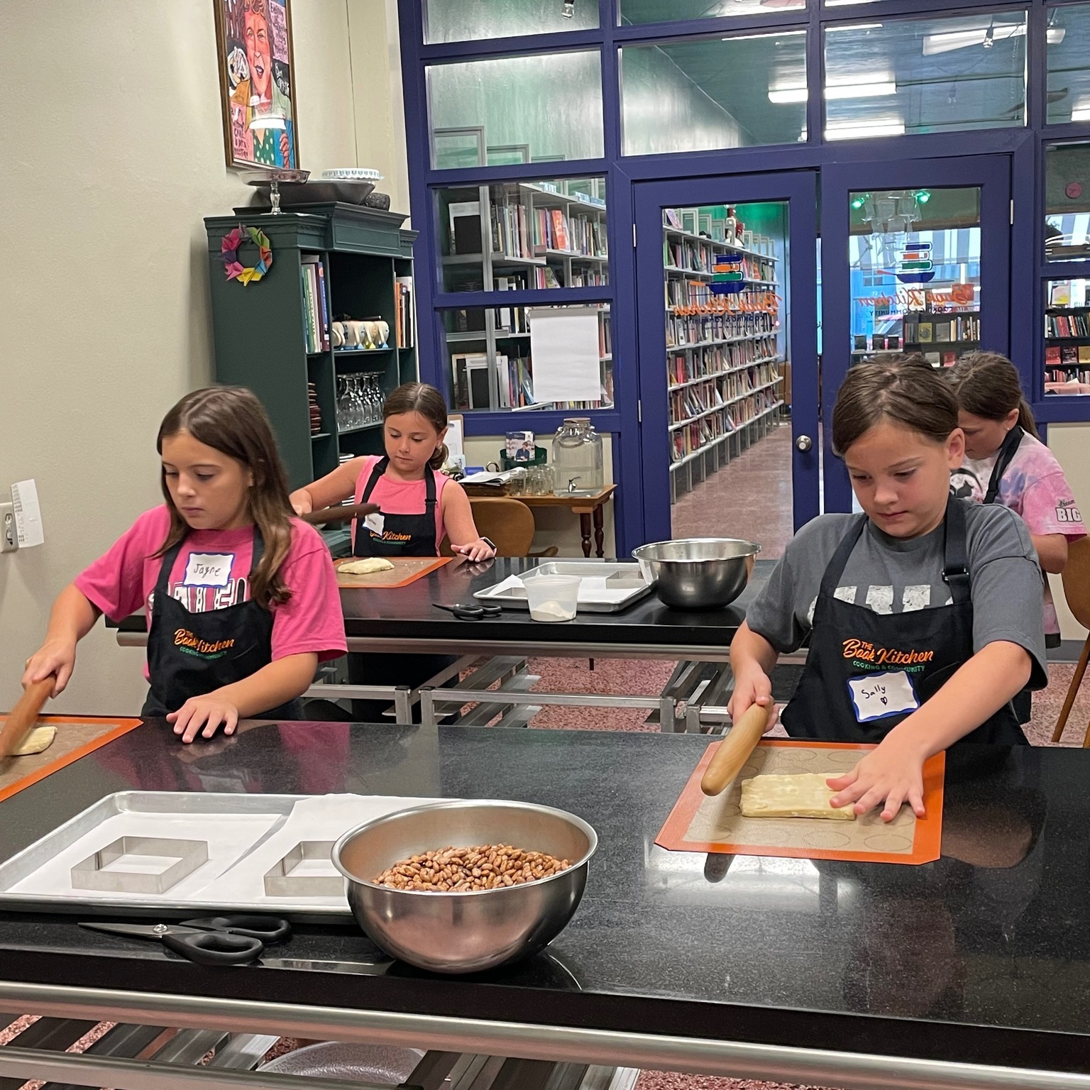 kids rolling dough at a birthday cooking party