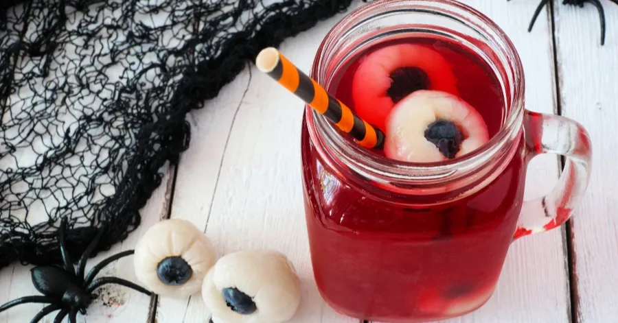 a cup with red punch and a spooky eyeball